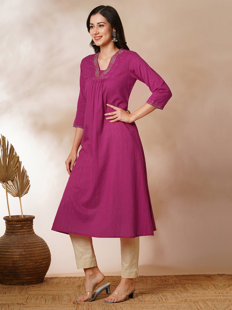 A-line woven cotton kurta with vibrant thread embroidery and gathering.