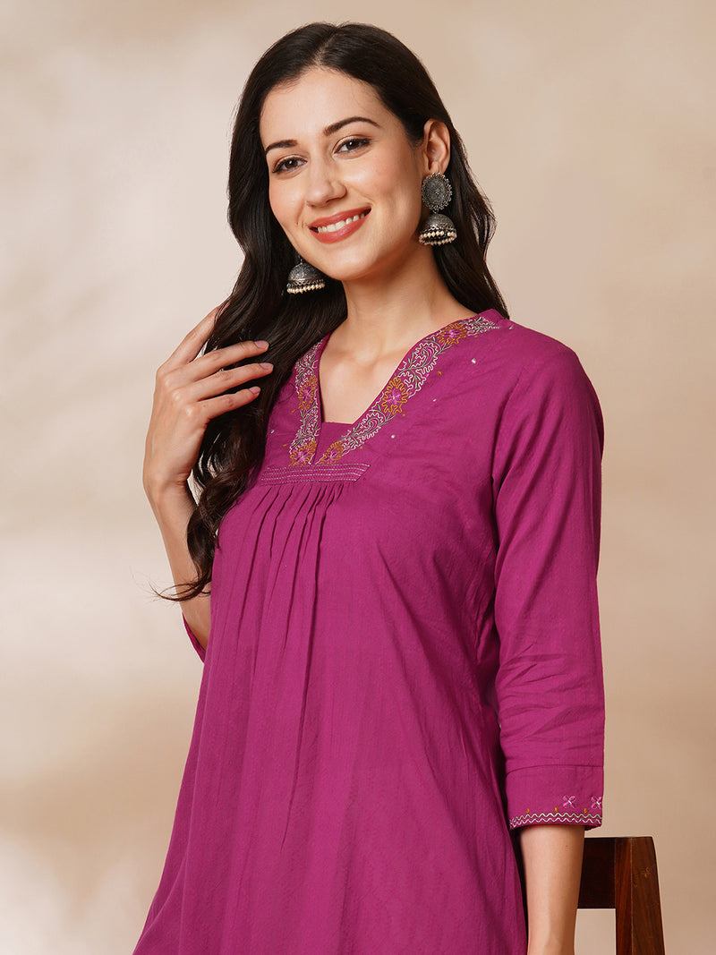 A-line woven cotton kurta with vibrant thread embroidery and gathering.