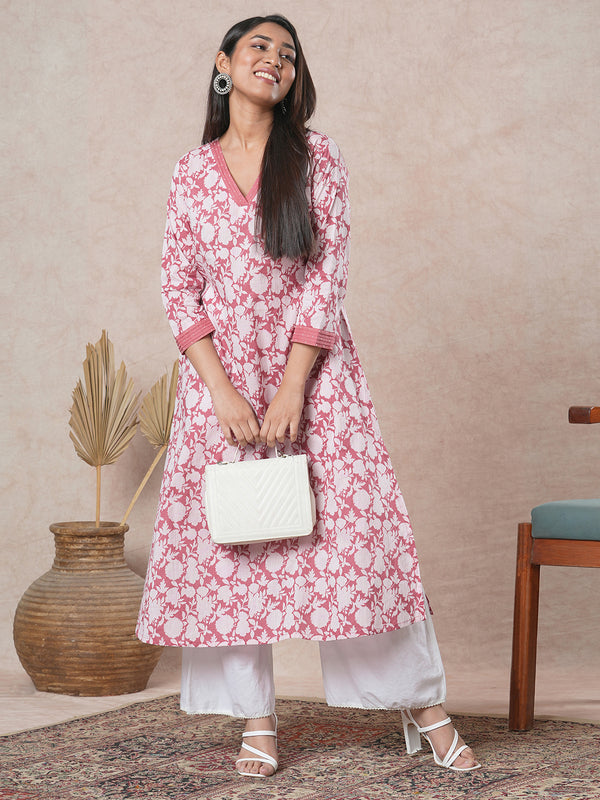 A-line cotton printed kurta with bead detailing around pleated V-neck and sleeve.