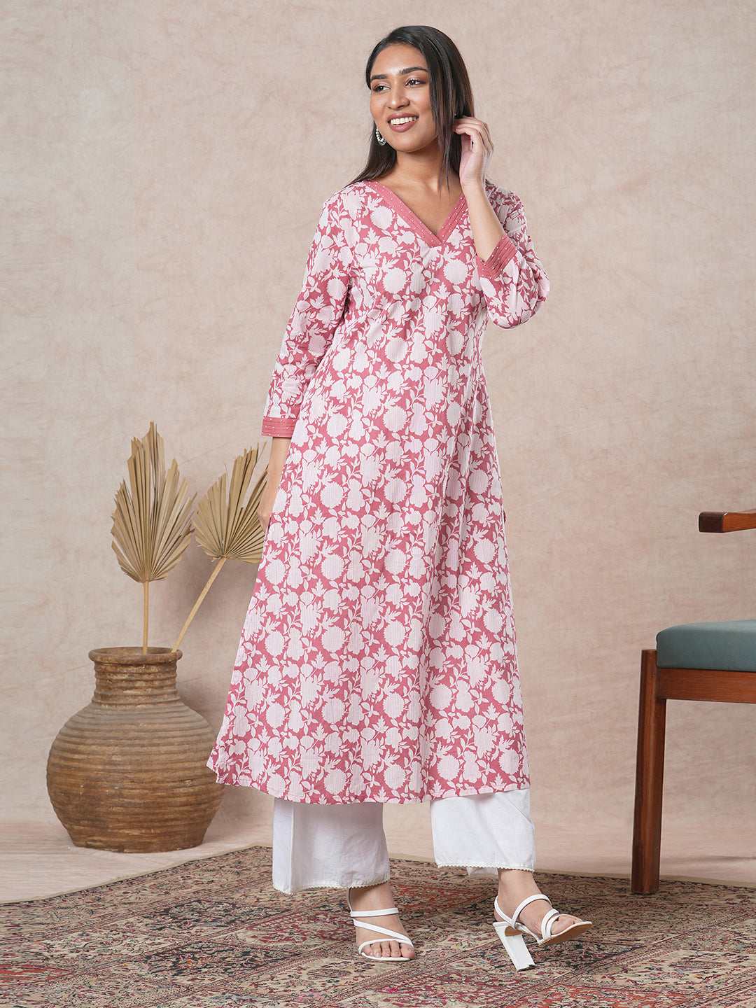A-line cotton printed kurta with bead detailing around pleated V-neck and sleeve