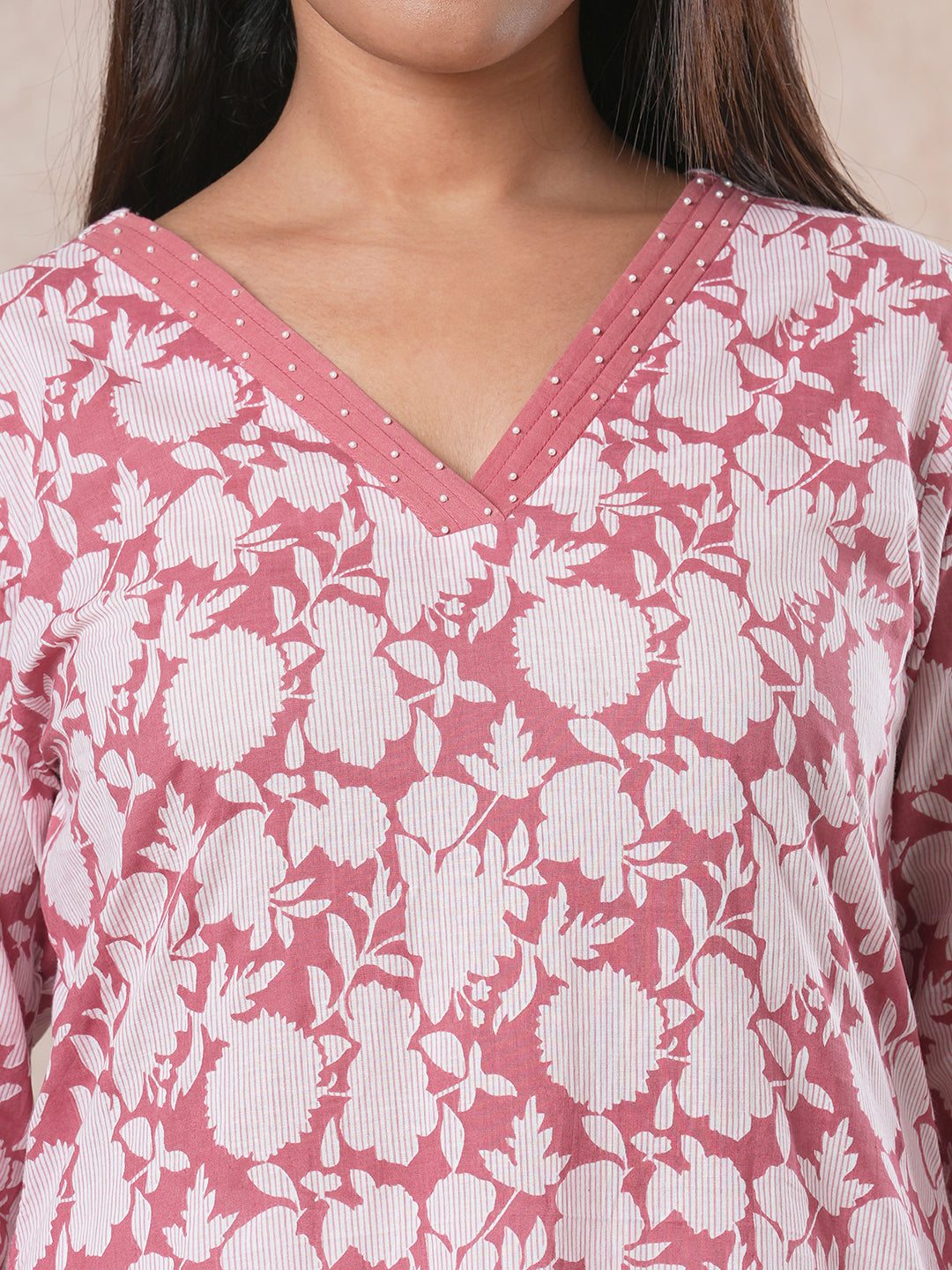 A-line cotton printed kurta with bead detailing around pleated V-neck and sleeve