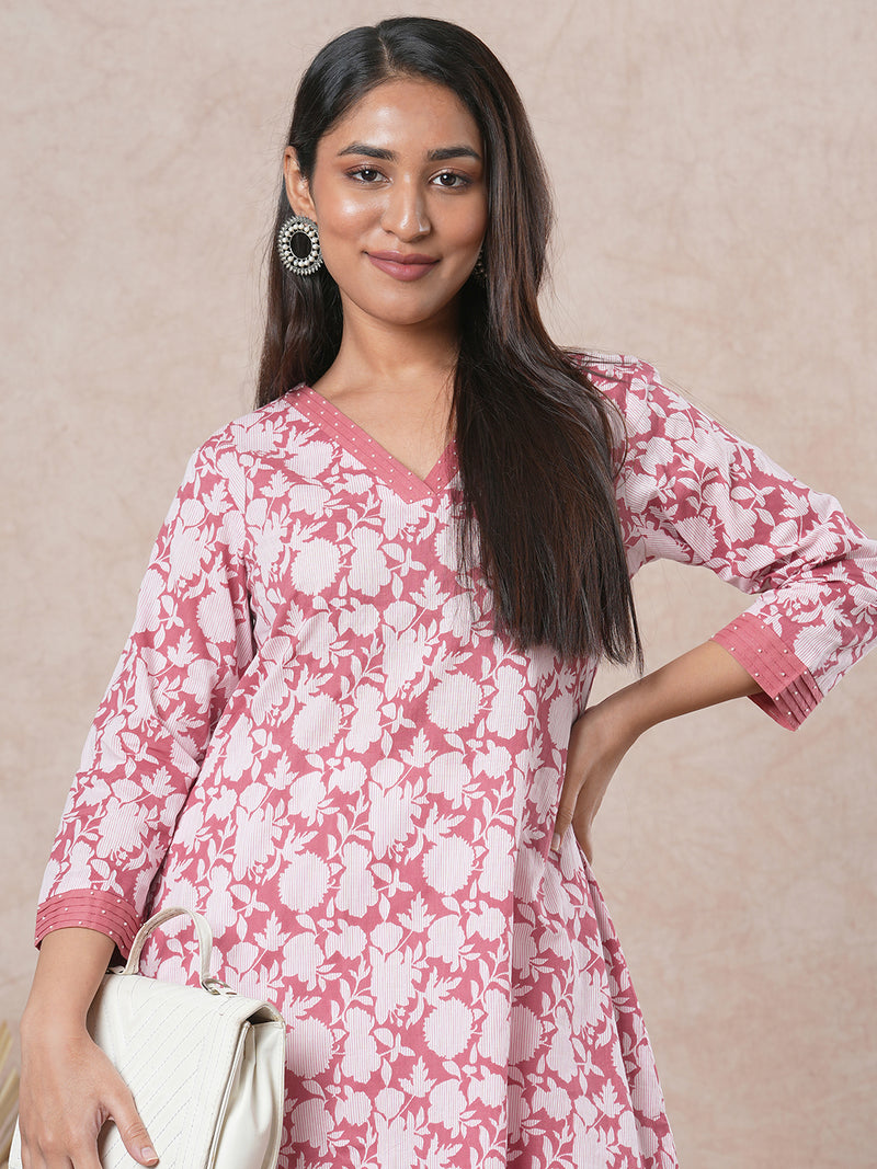 A-line cotton printed kurta with bead detailing around pleated V-neck and sleeve.