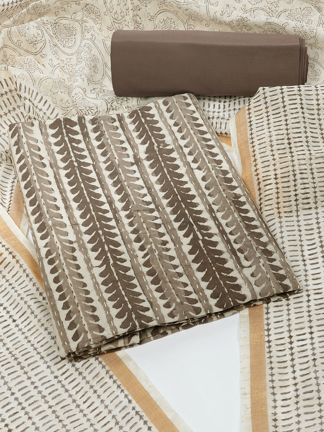 Brown unstitched suit set with traditional dabu print along with printed dupatta and solid bottom