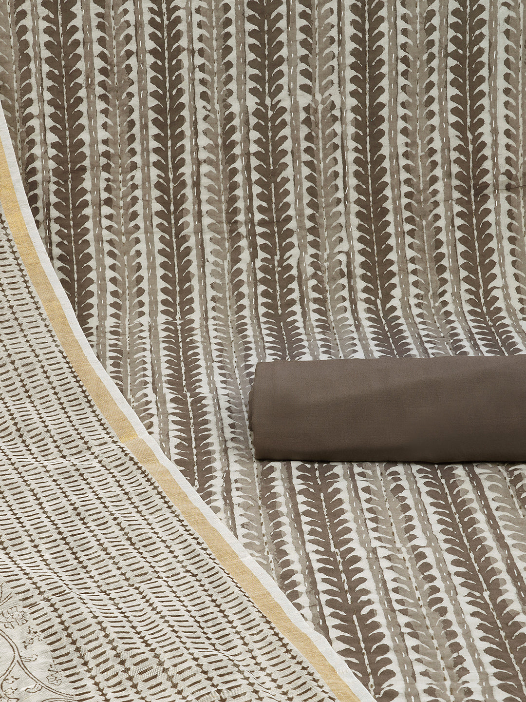 Brown unstitched suit set with traditional dabu print along with printed dupatta and solid bottom