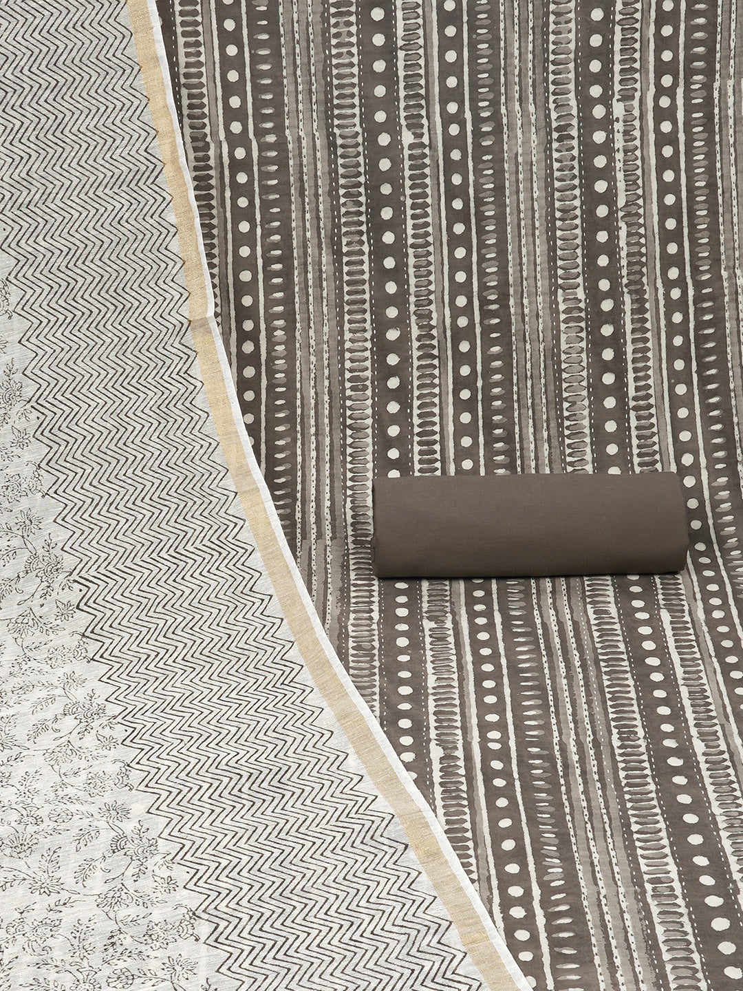 Brown unstitched suit set with traditional geometric dabu print along with printed dupatta and solid bottom