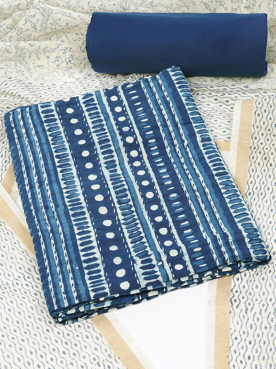 Blue unstitched suit set with traditional geometric dabu print along with printed dupatta and solid bottom