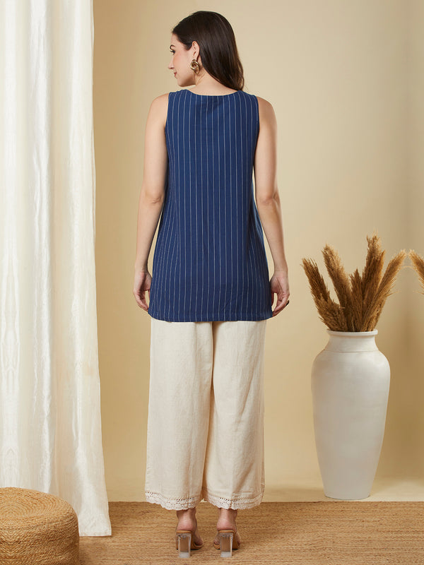 Sleeveless up and down top in woven cotton with embroidery detailing.