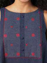 A-line south cotton tunic with checkered yoke and placket on front.