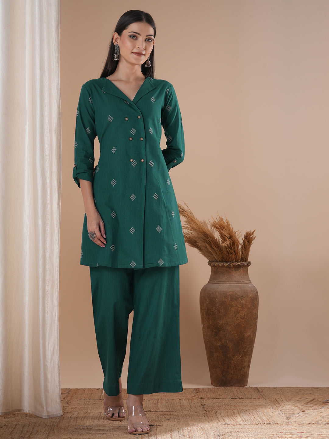 A co-Ord set with a lapel collar top with loop detailing on the sleeves paired with solid palazzos