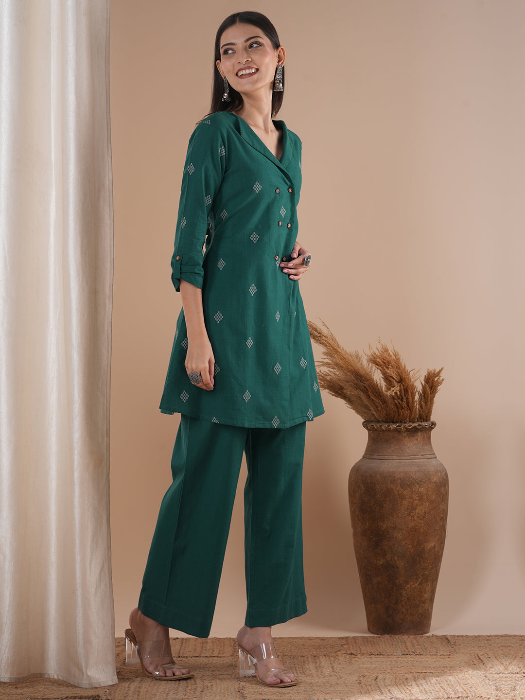 A co-Ord set with a lapel collar top with loop detailing on the sleeves paired with solid palazzos