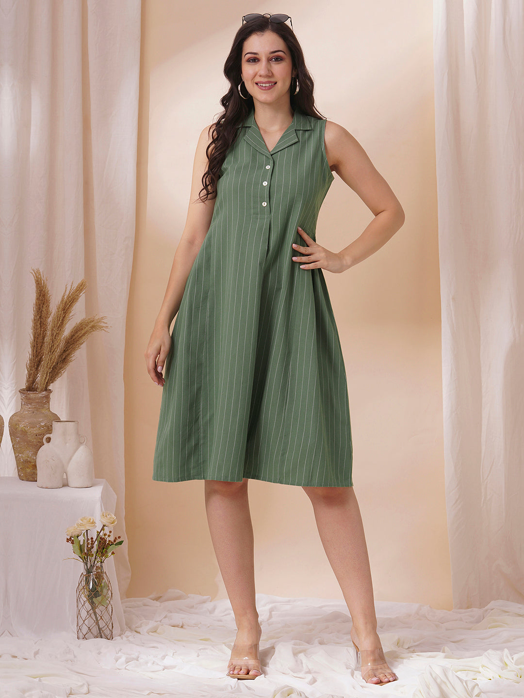 Striped sleeveless dress with notch collar and a side box pleat.