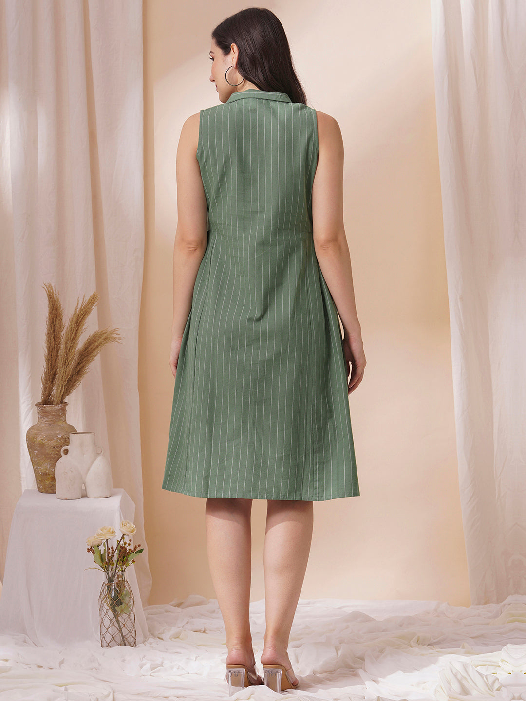 Striped sleeveless dress with notch collar and a side box pleat.