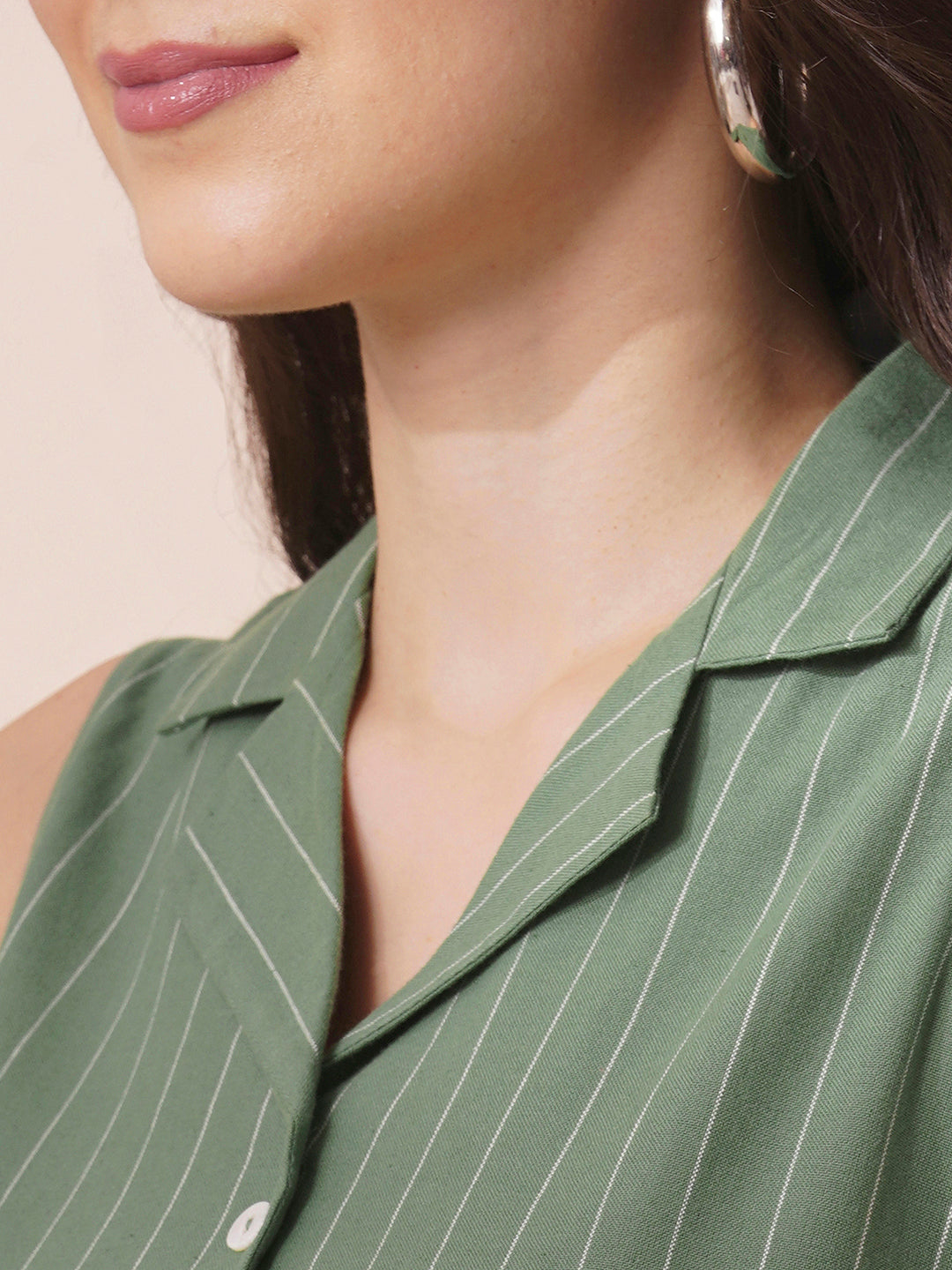 Striped sleeveless dress with notch collar and a side box pleat.