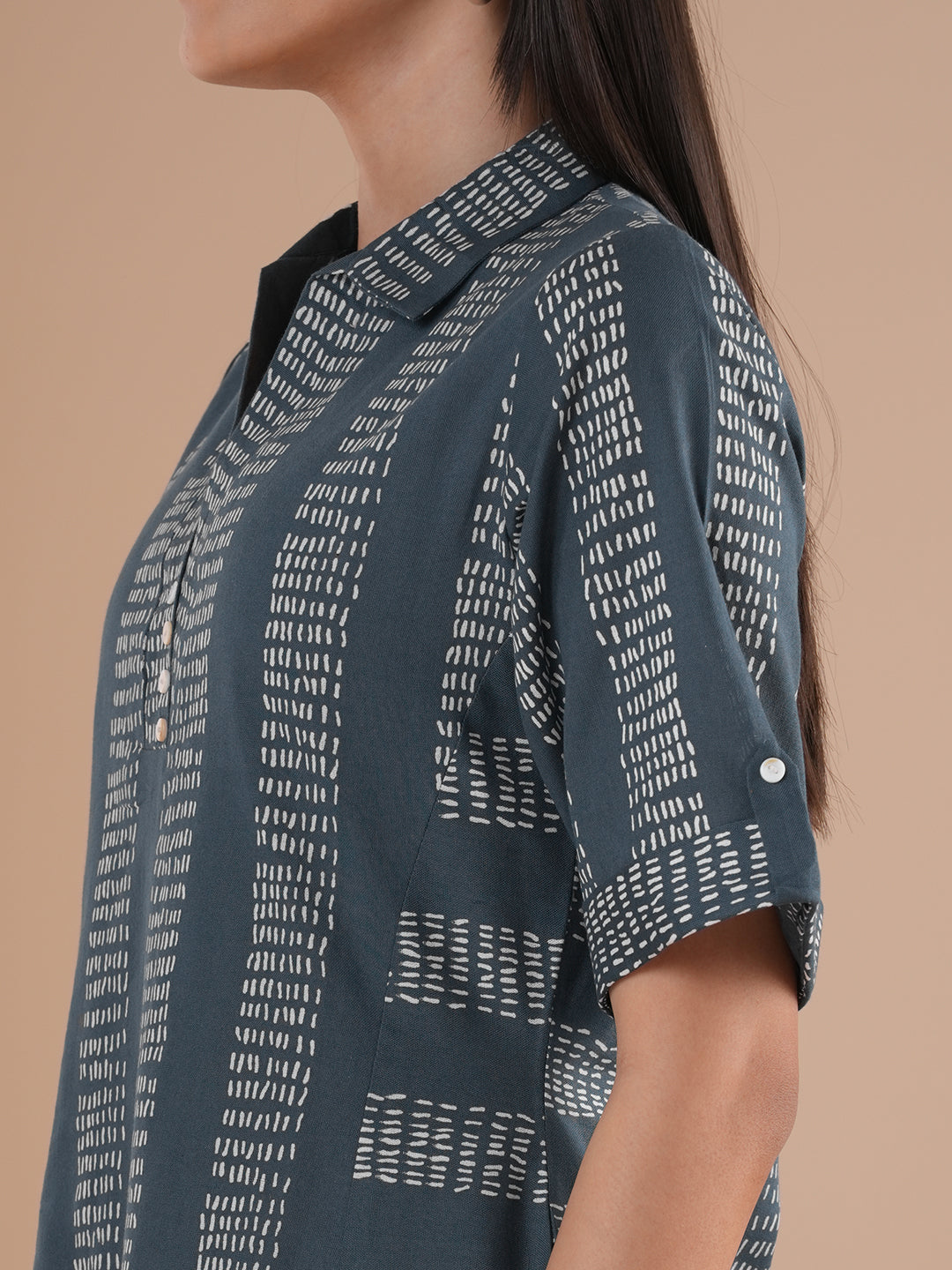 A collared printed dress with stripe manipulation panels, dual pockets and half sleeves with cuff