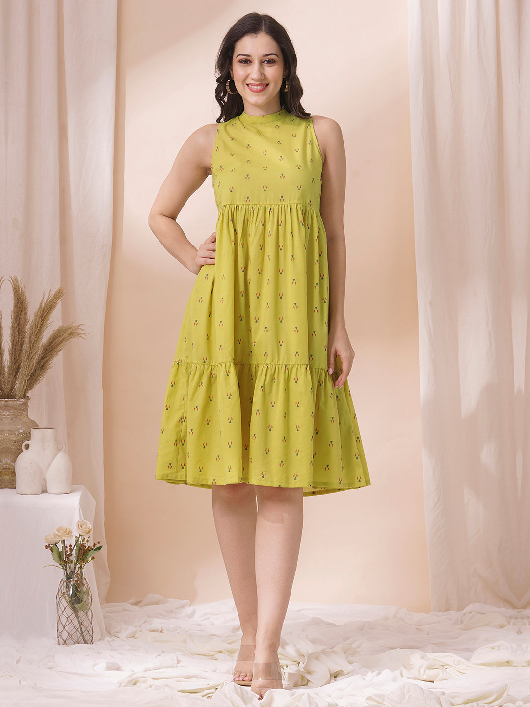 Gathered tiered sleeveless dress with back neck tie-up detailing on dobby fabric.