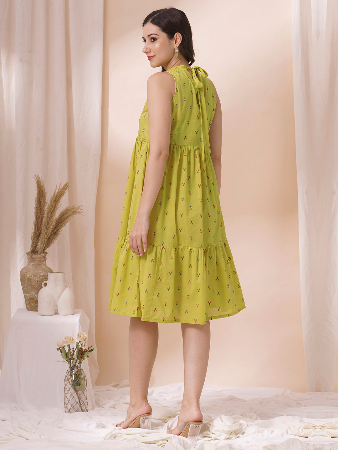 Gathered tiered sleeveless dress with back neck tie-up detailing on dobby fabric.