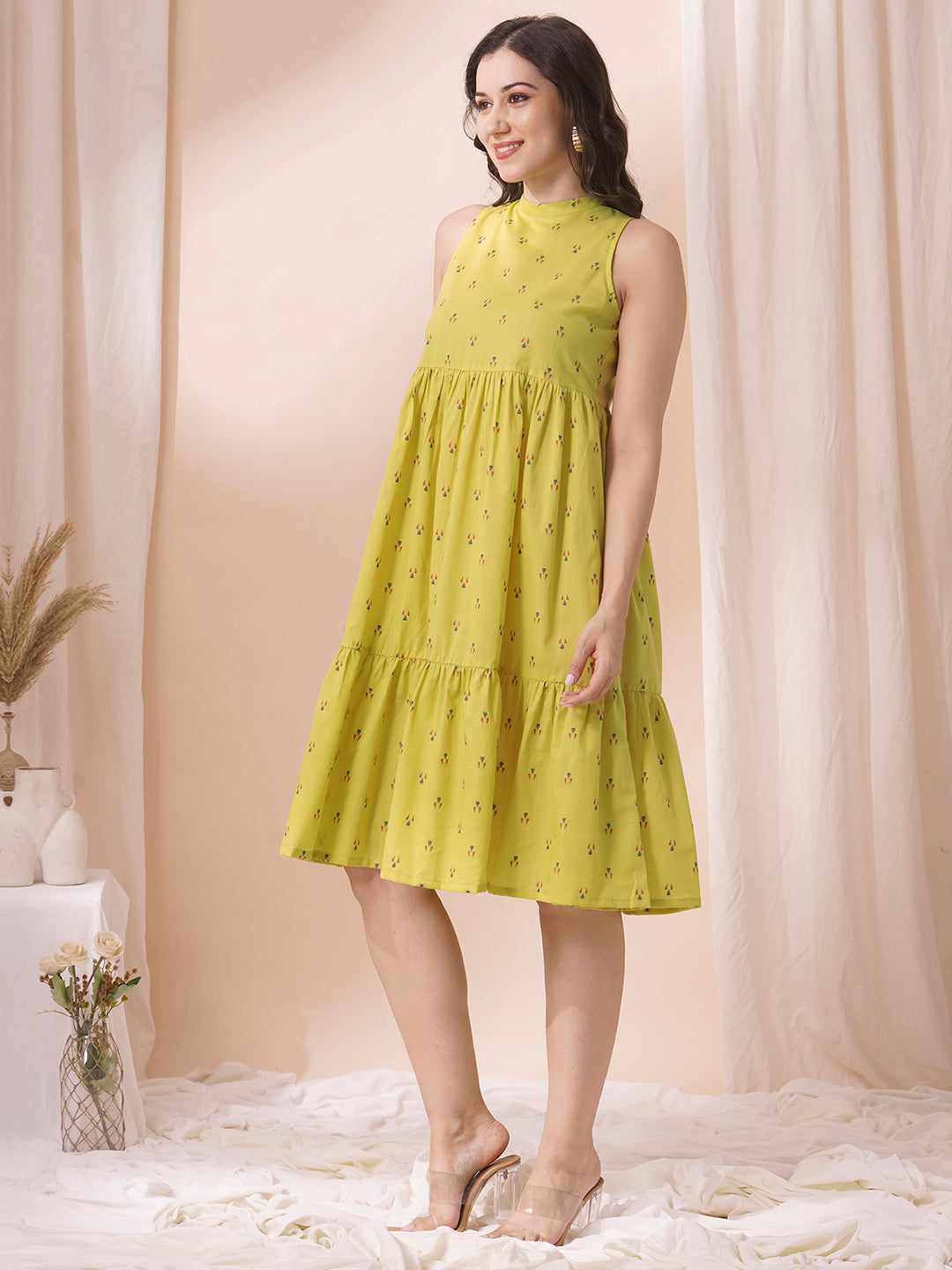 Gathered tiered sleeveless dress with back neck tie-up detailing on dobby fabric.