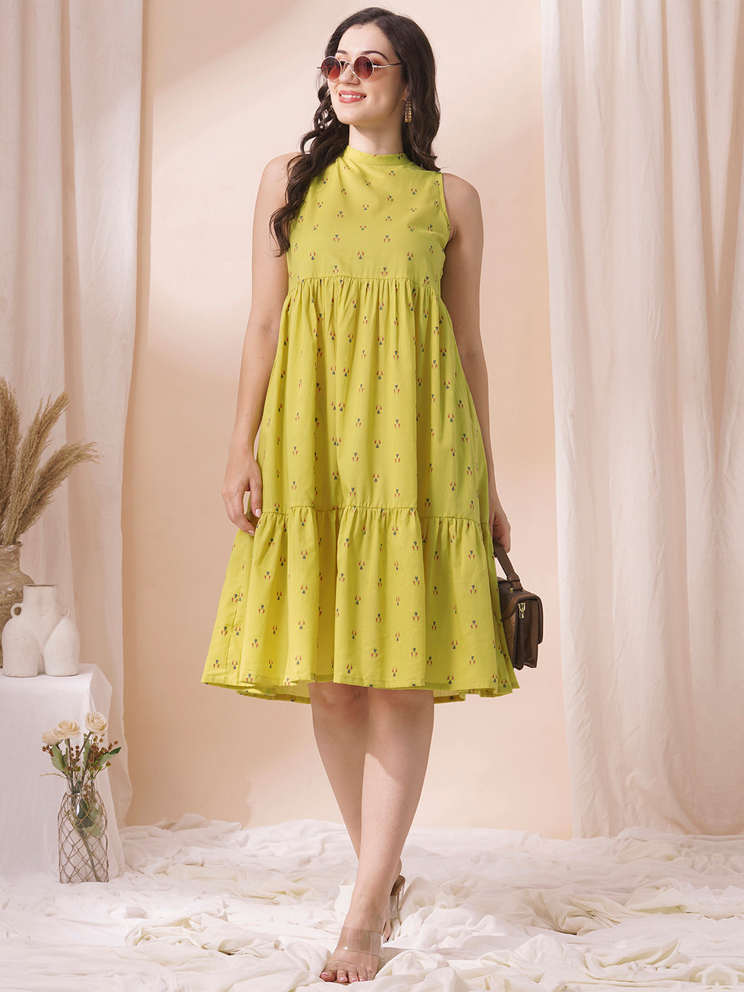 Gathered tiered sleeveless dress with back neck tie-up detailing on dobby fabric.