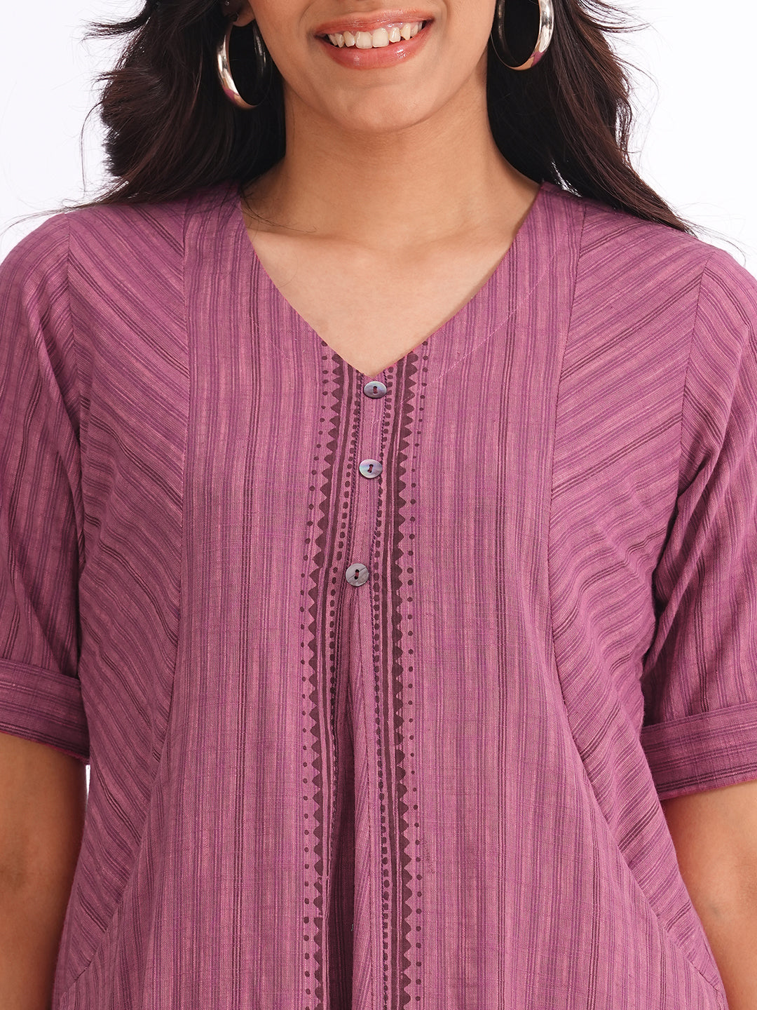 woven striped dress highlighted with block print and shaped side panels with pockets