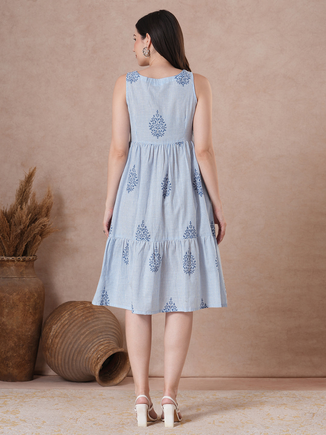 Woven striped and screen printed tiered dress with tie-up on neck with tassels.