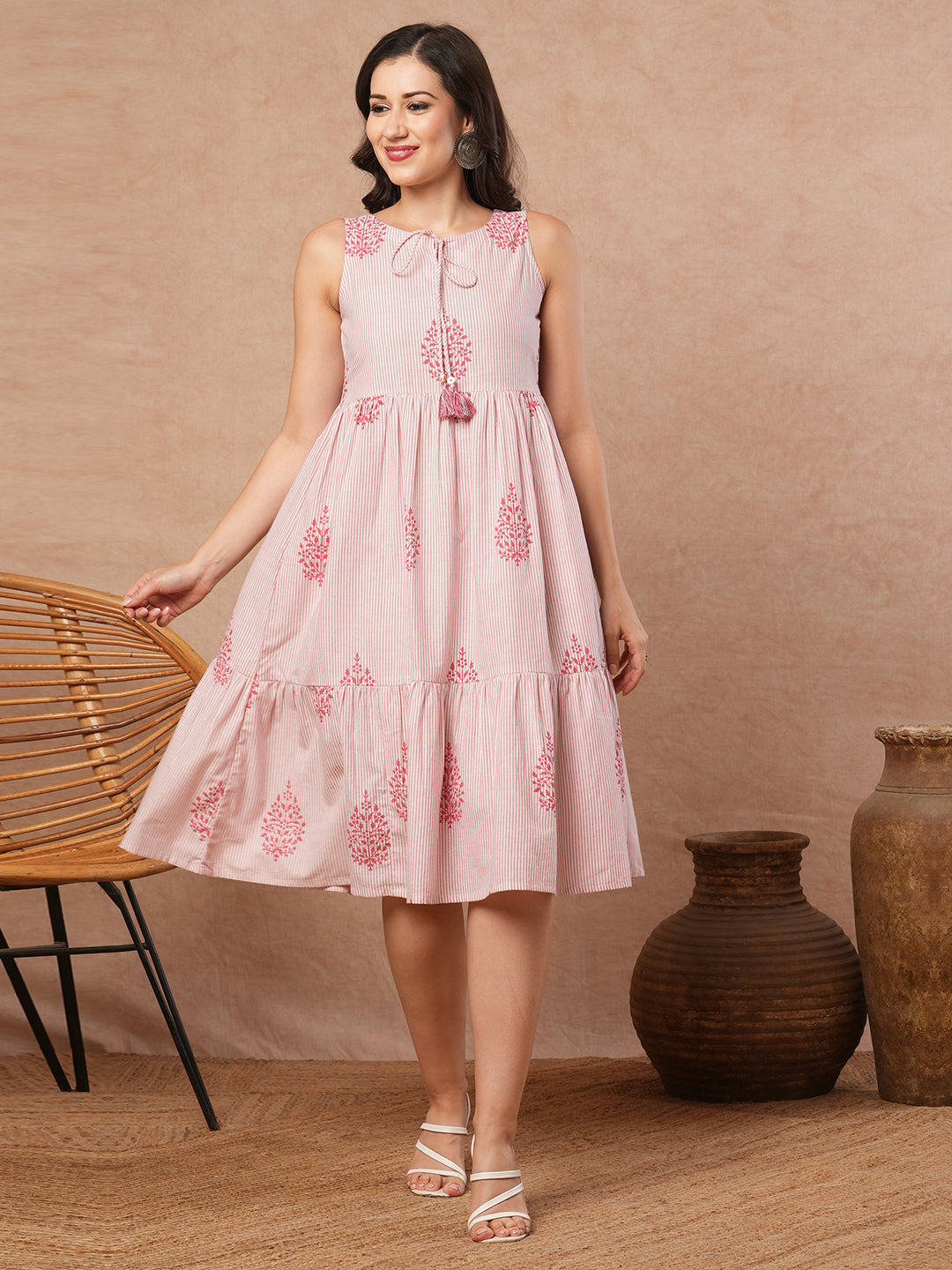 Woven striped and screen printed tiered dress with tie-up on neck with tassels.