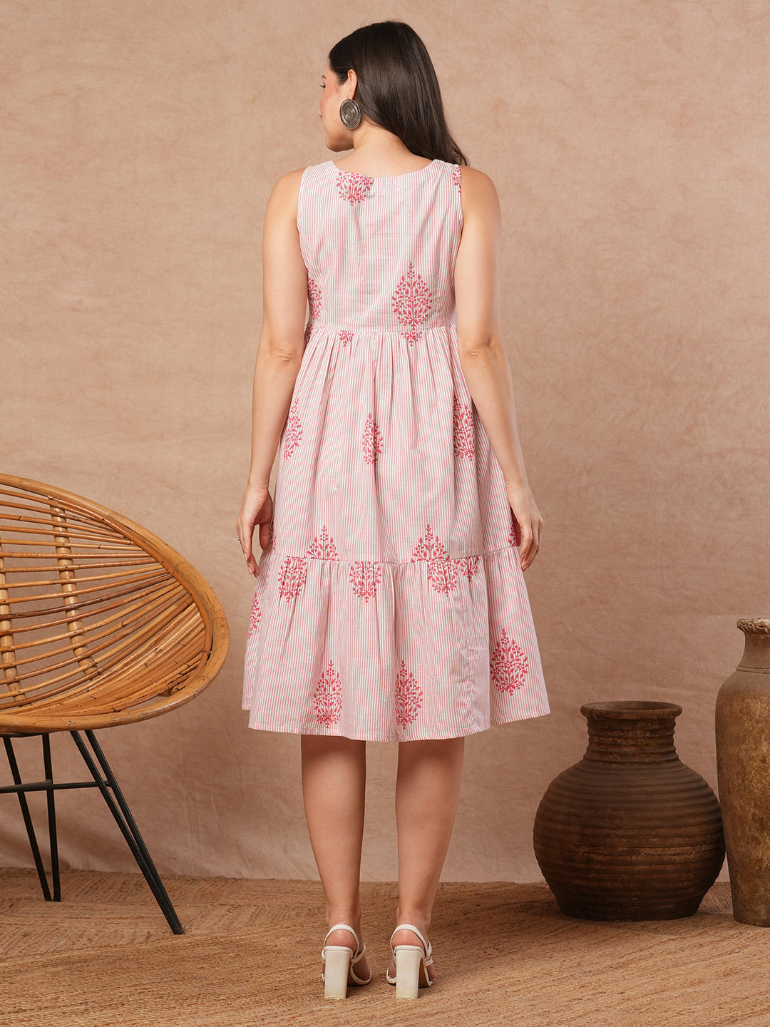 Woven striped and screen printed tiered dress with tie-up on neck with tassels.