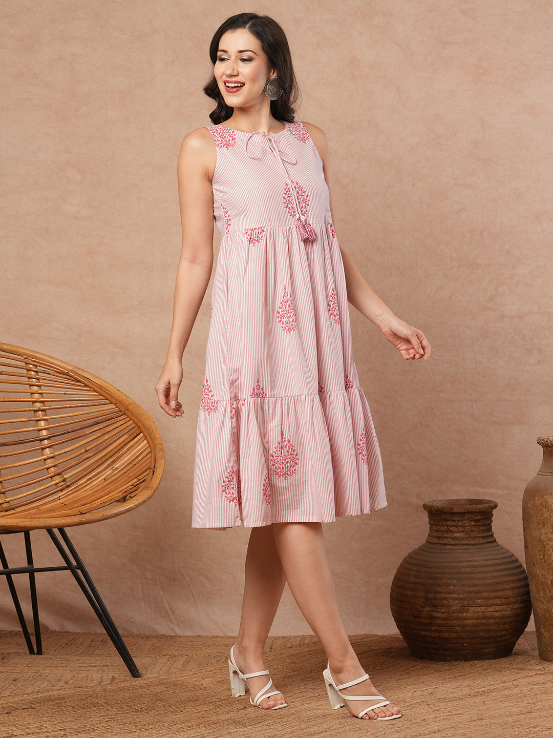 Woven striped and screen printed tiered dress with tie-up on neck with tassels.