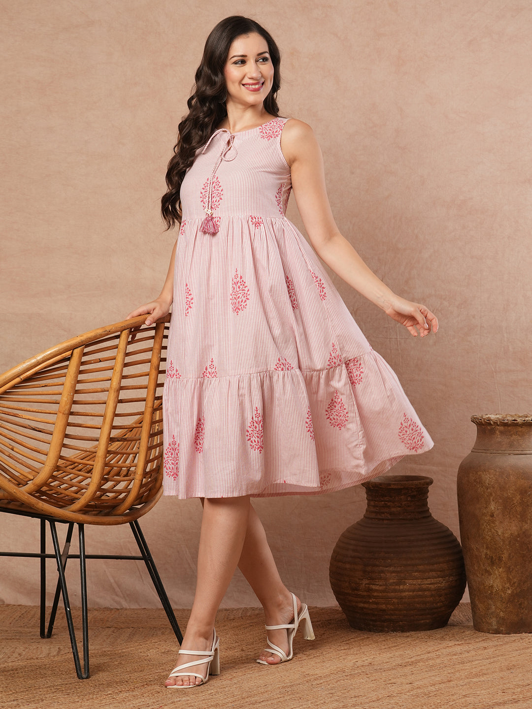 Woven striped and screen printed tiered dress with tie-up on neck with tassels.