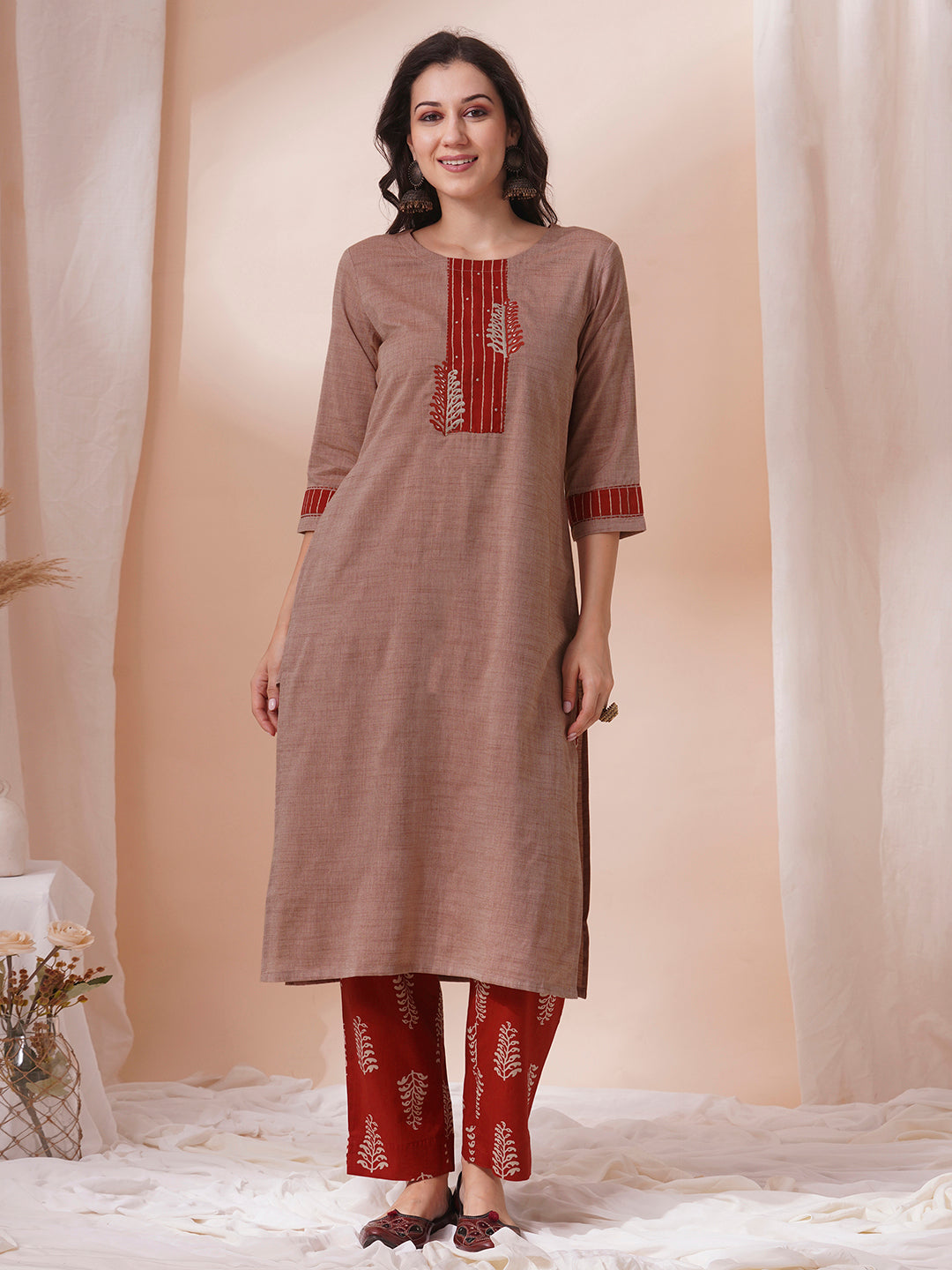 The kurta suit set features a machine embroidered and trim detail.