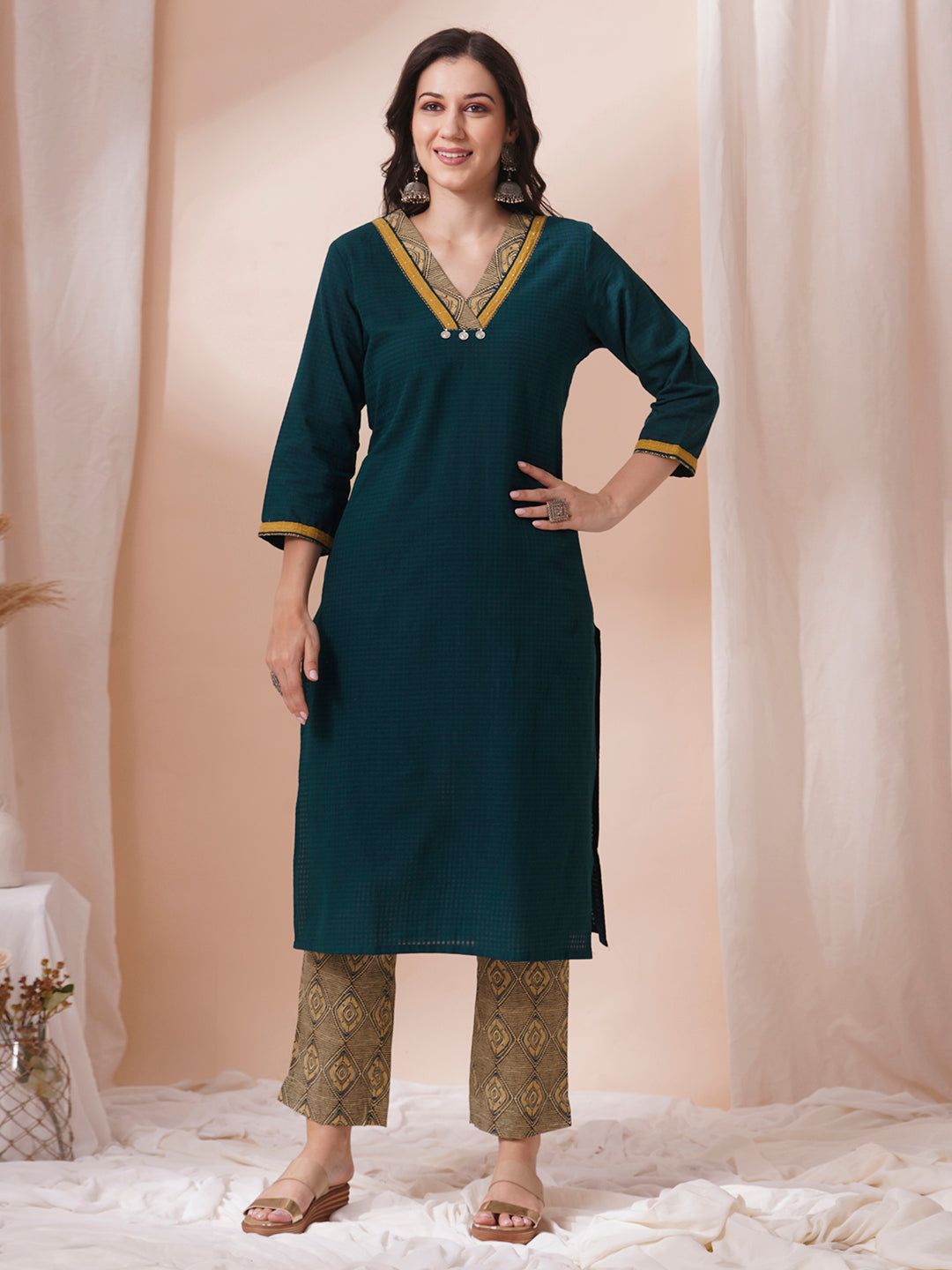 Forest green straight fit kurta suit set crafted with self dobby cotton fabric paired with geometric print bottom and applique dupatta.