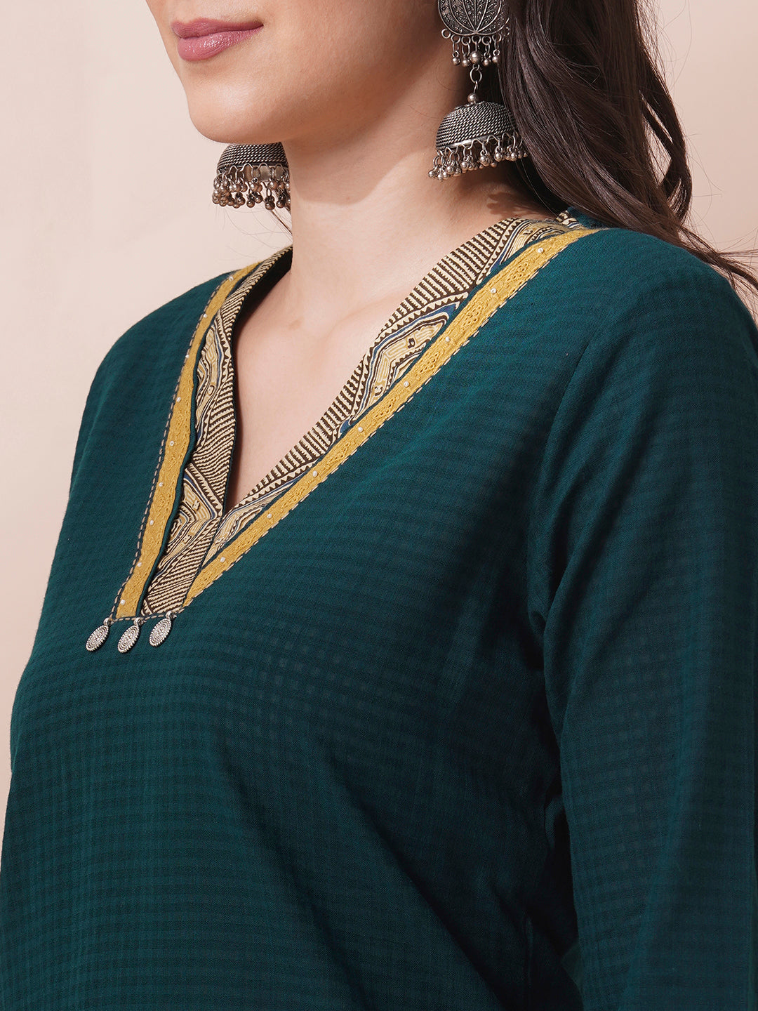 Forest green straight fit kurta suit set crafted with self dobby cotton fabric paired with geometric print bottom and applique dupatta.