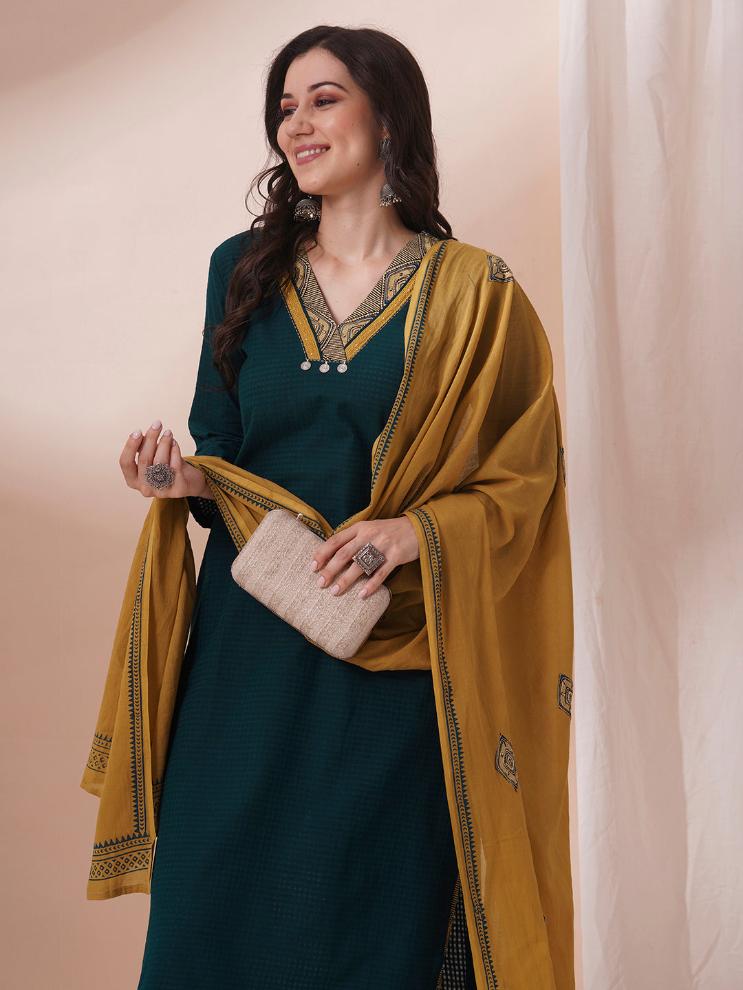 Forest green straight fit kurta suit set crafted with self dobby cotton fabric paired with geometric print bottom and applique dupatta.