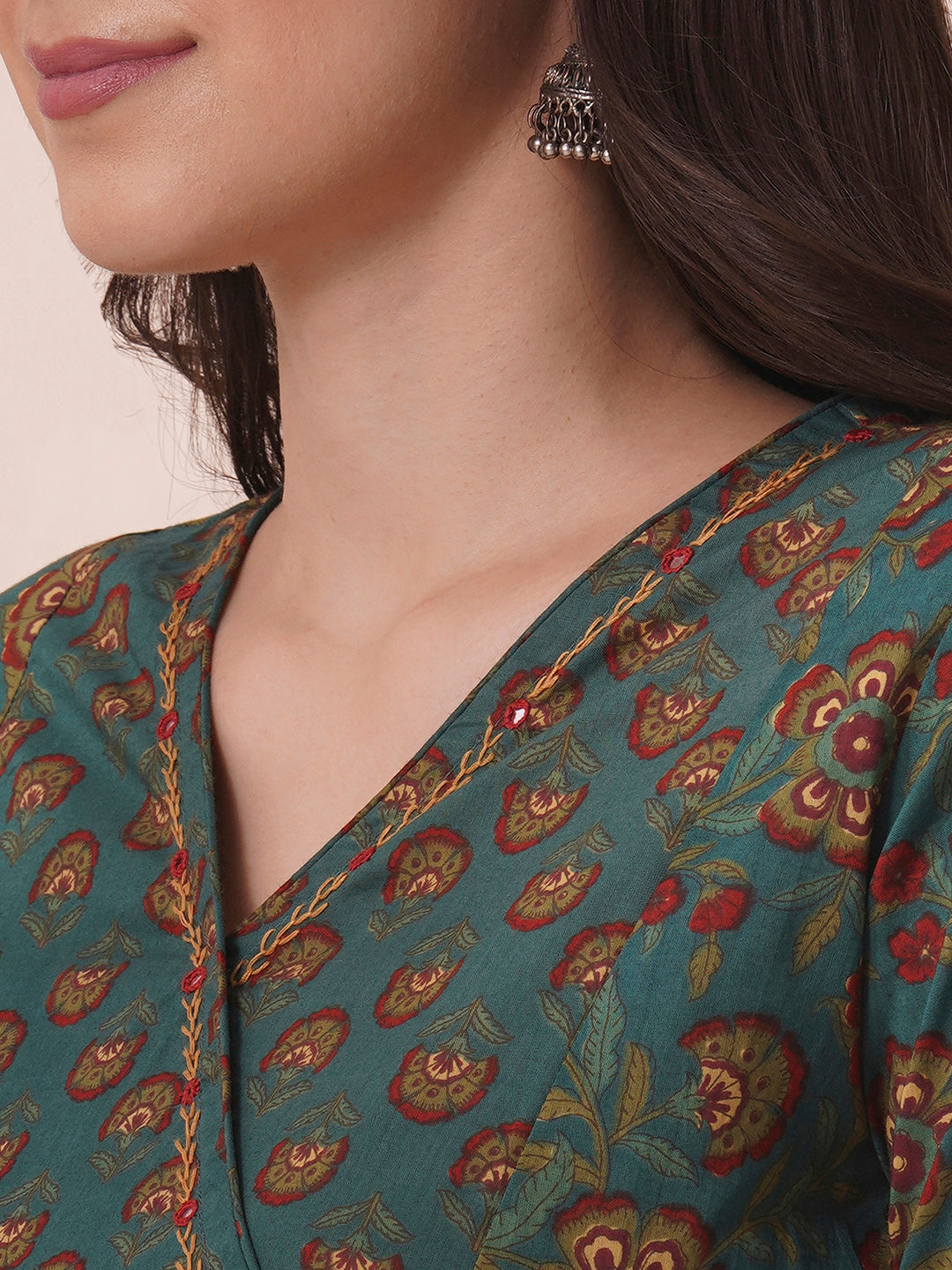 Fit and flare cotton print kurta with hand embroidery, overlap yoke and fabric tassels.