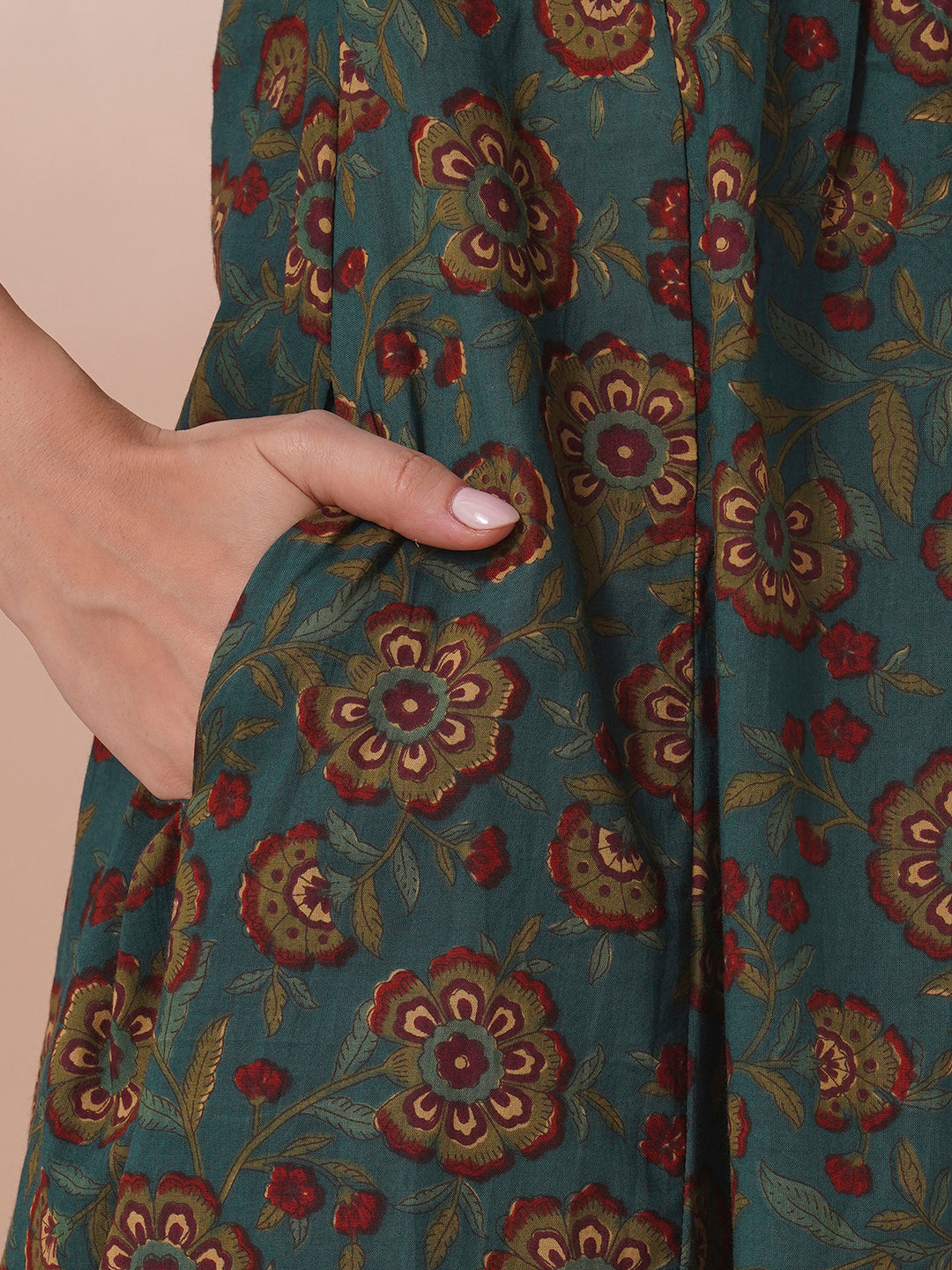 Fit and flare cotton print kurta with hand embroidery, overlap yoke and fabric tassels.