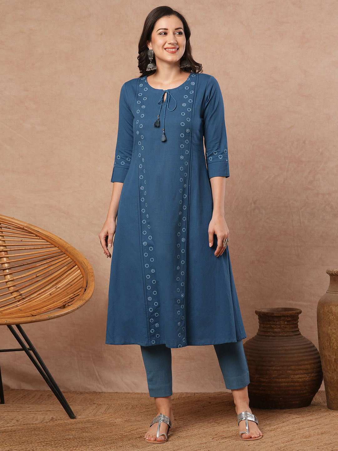 A-line cotton flex kurta with mirror work and attached thread tassels.