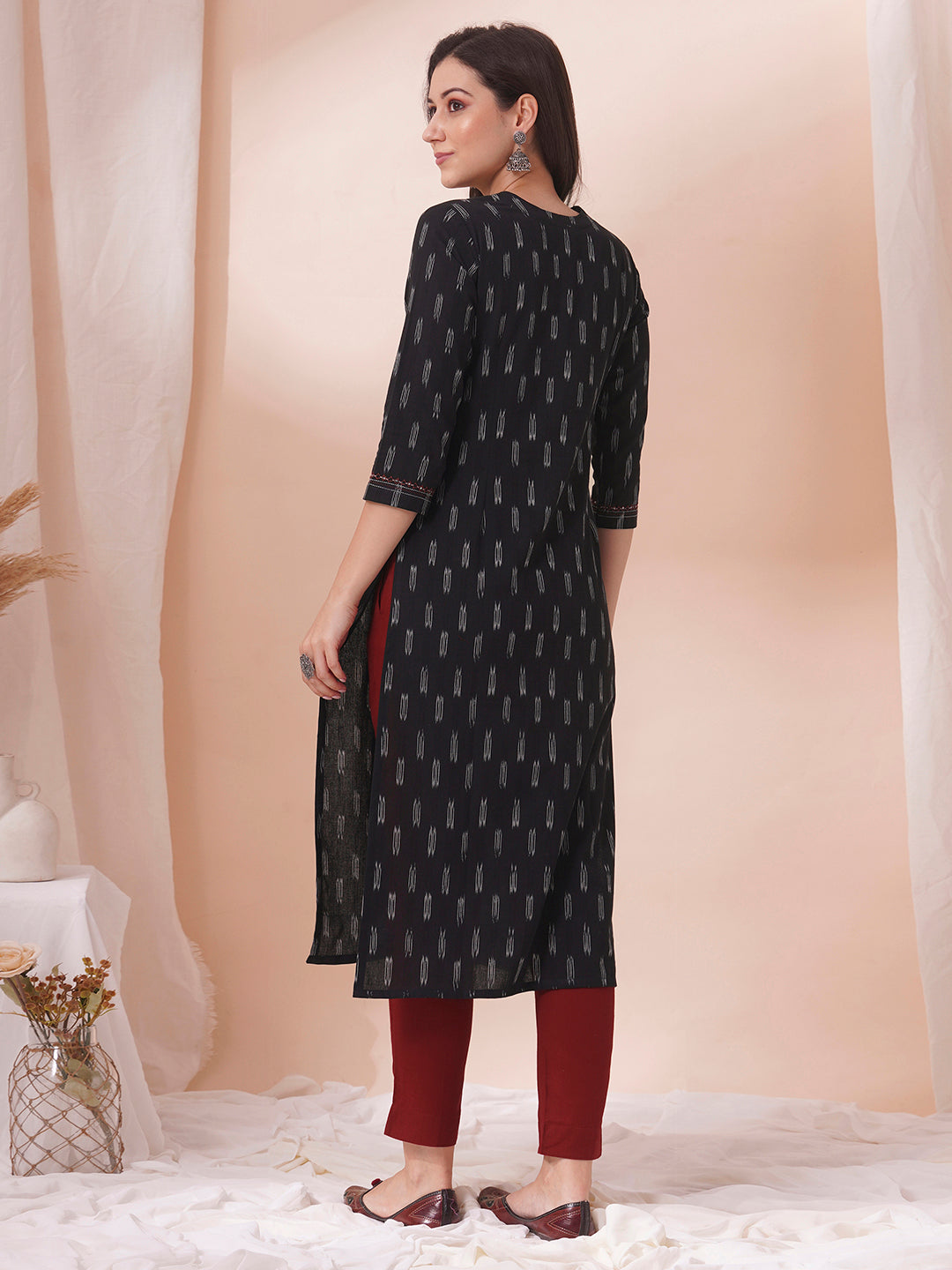 Straight fit cotton kurta in woven ikkat fabric with stitch lines and hand embroidery.