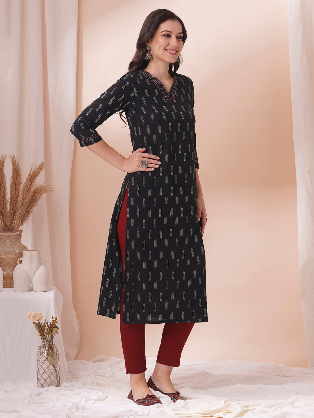 Straight fit cotton kurta in woven ikkat fabric with stitch lines and hand embroidery.
