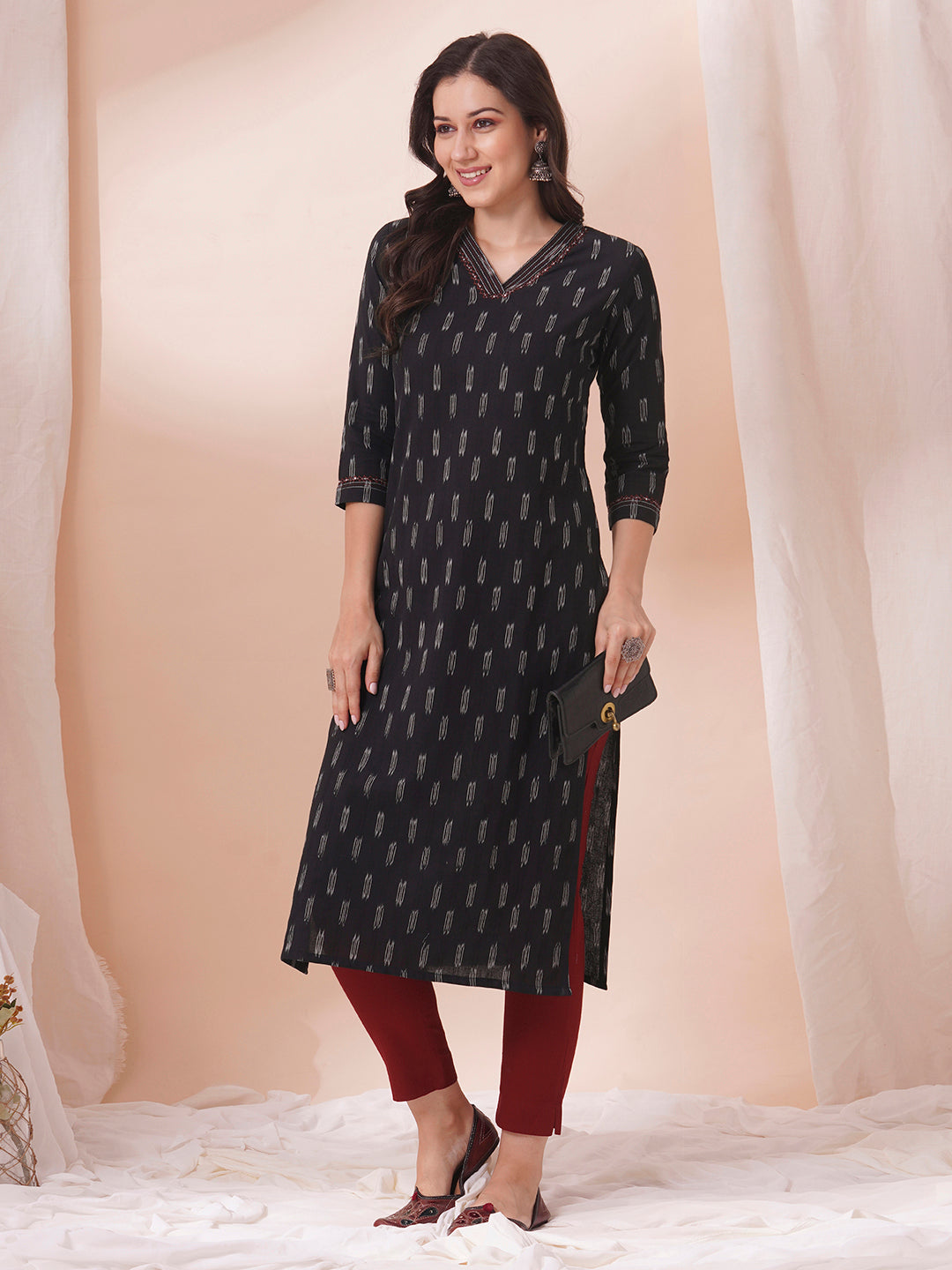 Straight fit cotton kurta in woven ikkat fabric with stitch lines and hand embroidery.