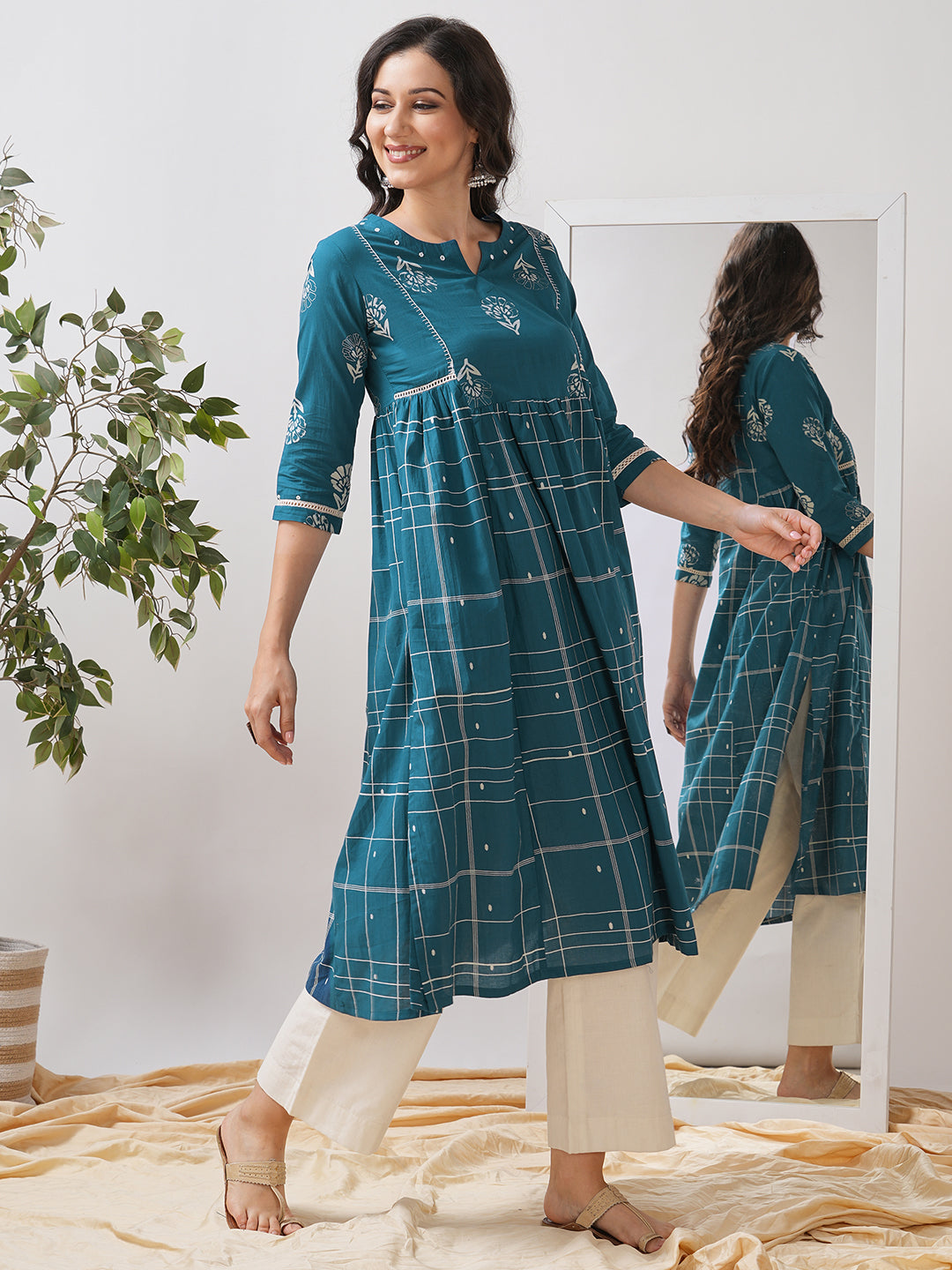 Pocketed A line kurta highlighted with lace, gathering and mirror work.
