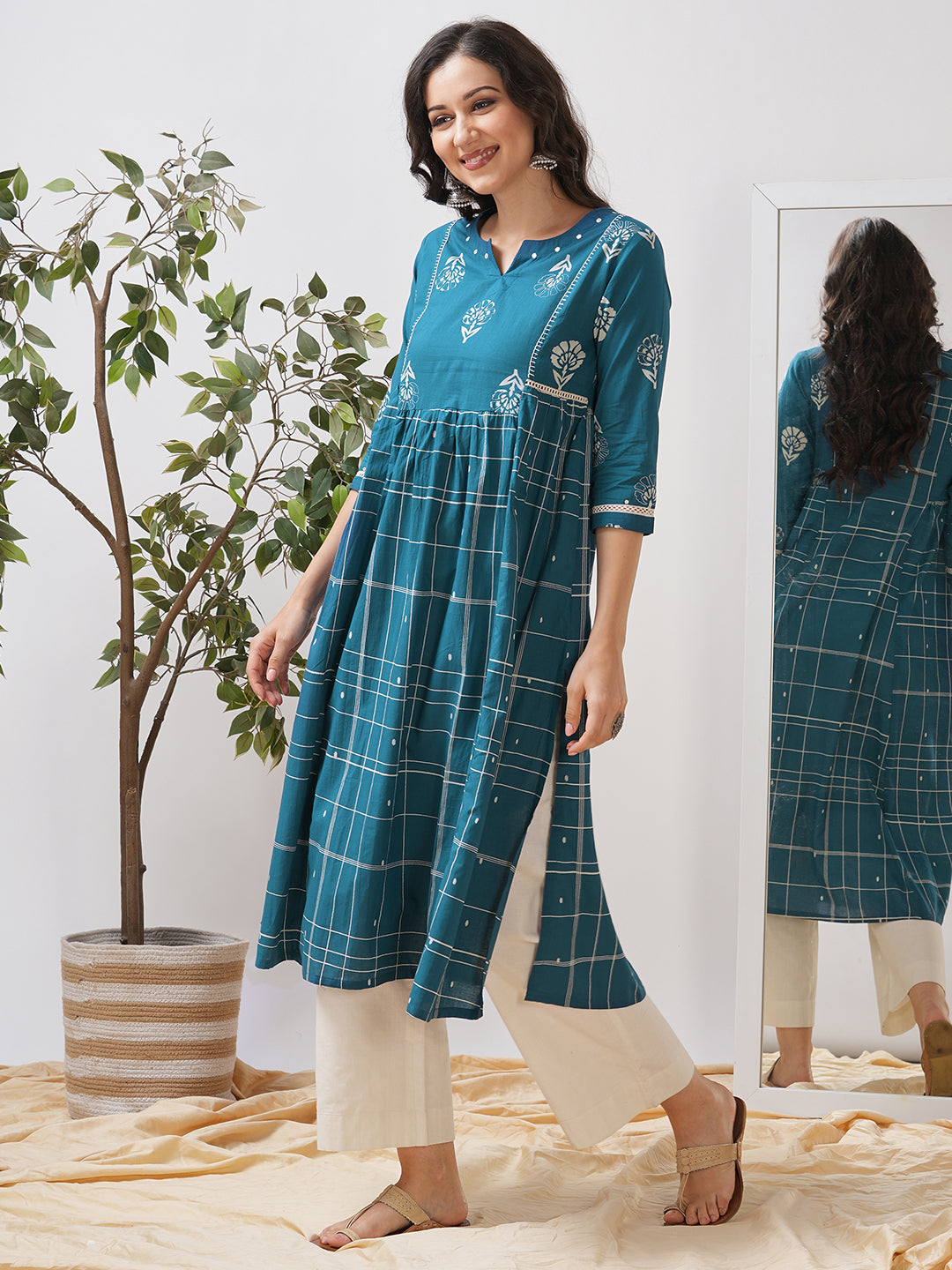 Pocketed A line kurta highlighted with lace, gathering and mirror work.