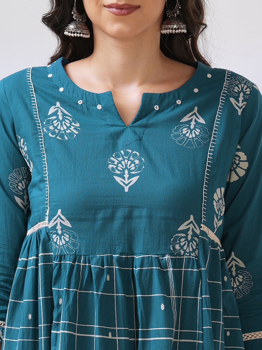 Pocketed A line kurta highlighted with lace, gathering and mirror work.