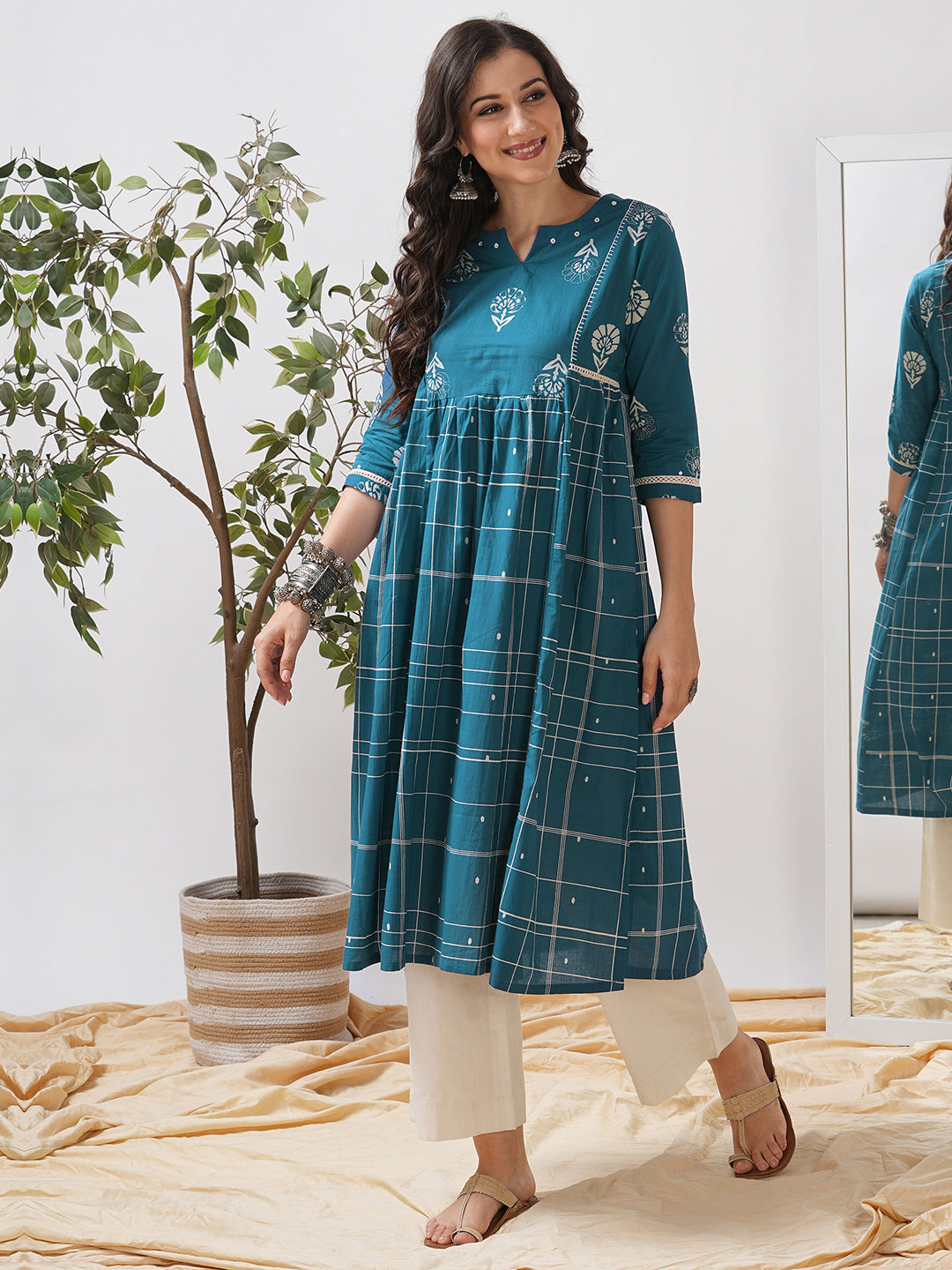 Pocketed A line kurta highlighted with lace, gathering and mirror work.