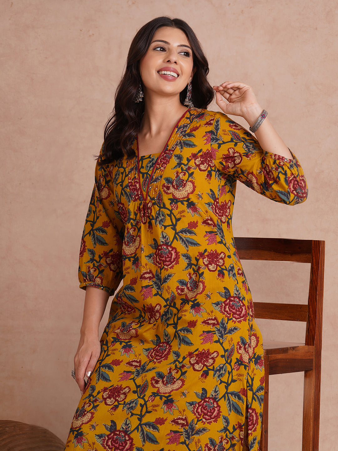 A-Line cotton print kurta with couching lines, sequin work, puffed sleeves and a pocket.