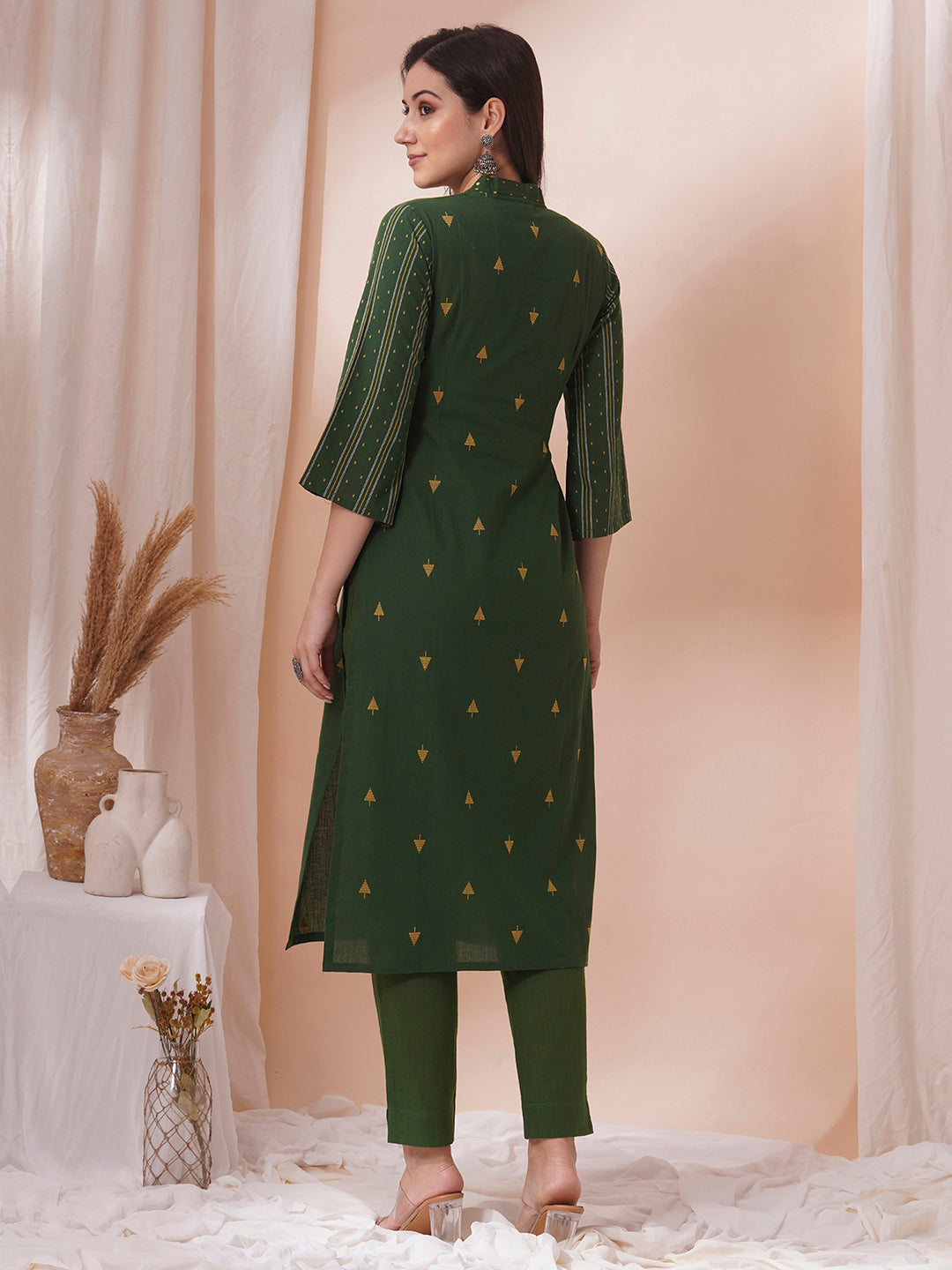 A centre pleated straight fit kurta in complimenting dobby fabric with mirror work.