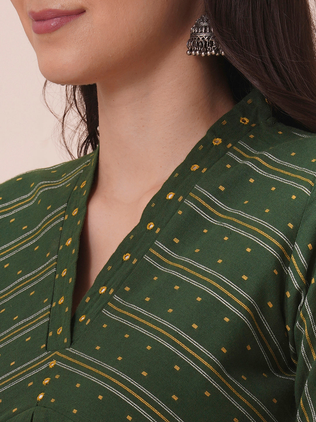 A centre pleated straight fit kurta in complimenting dobby fabric with mirror work.