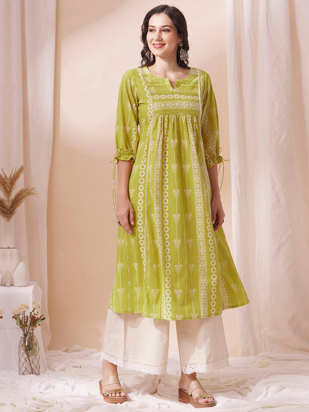 Shoulder princess A-line kurta with a horizontal stripe yoke with pintucks and mirrors.