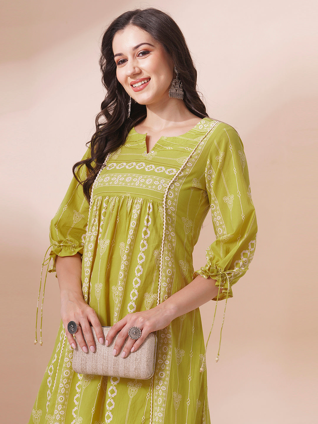 Shoulder princess A-line kurta with a horizontal stripe yoke with pintucks and mirrors.