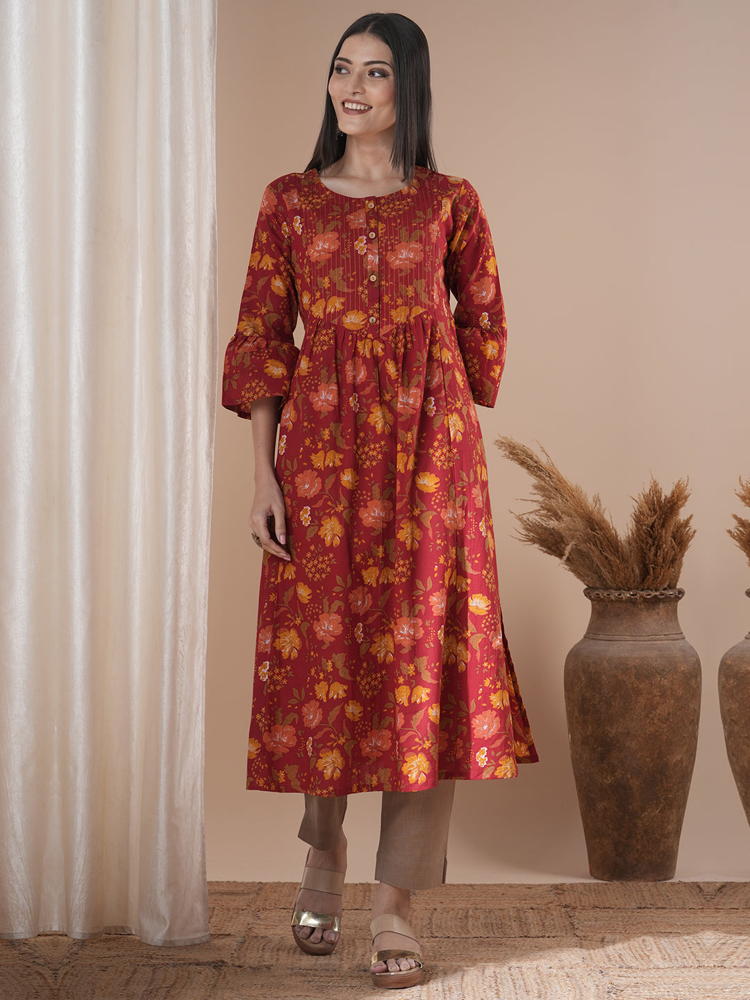 A printed shoulder princess A-line kurta with stitch lines on the shaped yoke and bell sleeves