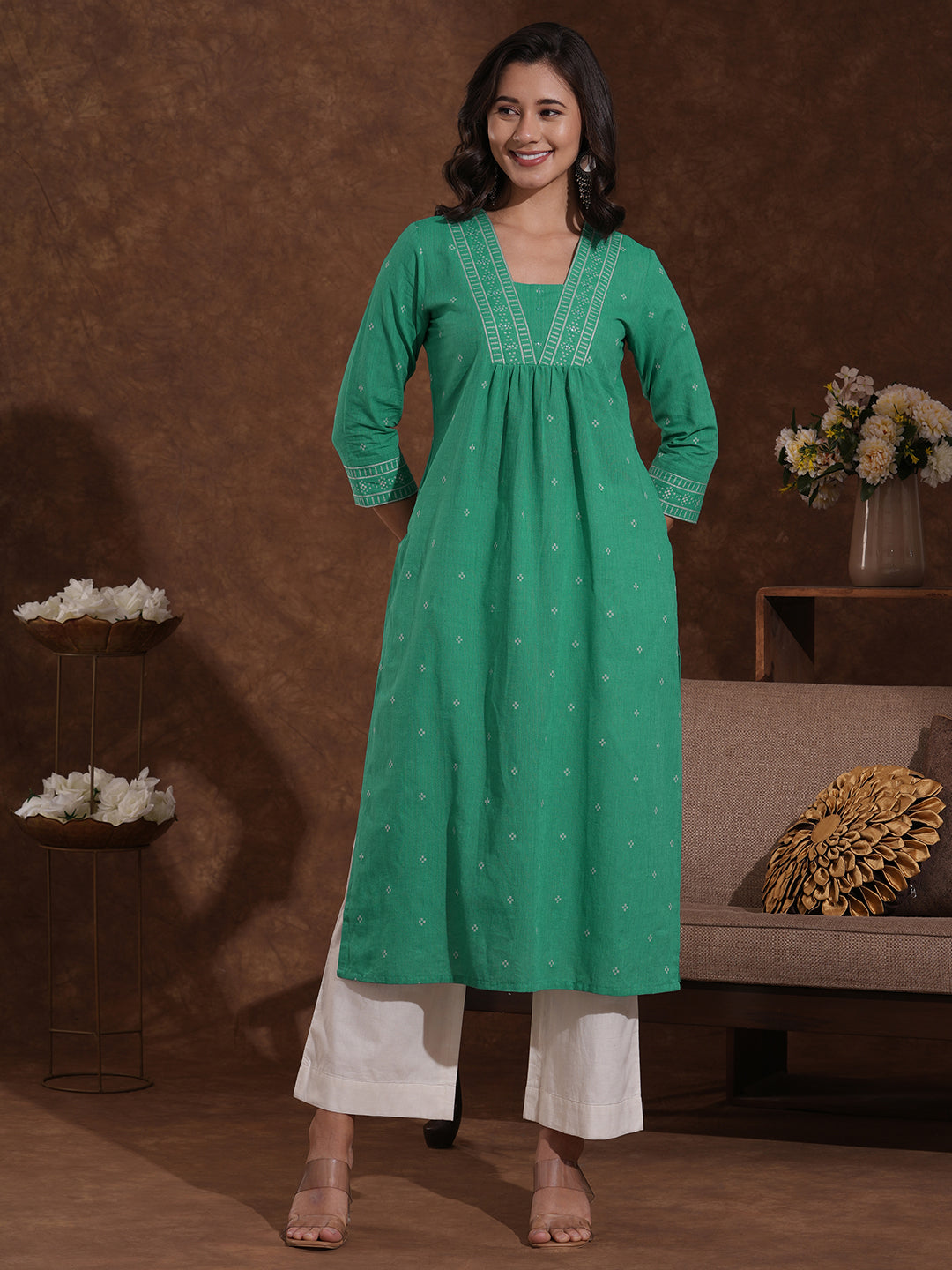 Straight kurta with border detailing on the neck and sleeves with mirrorwork.