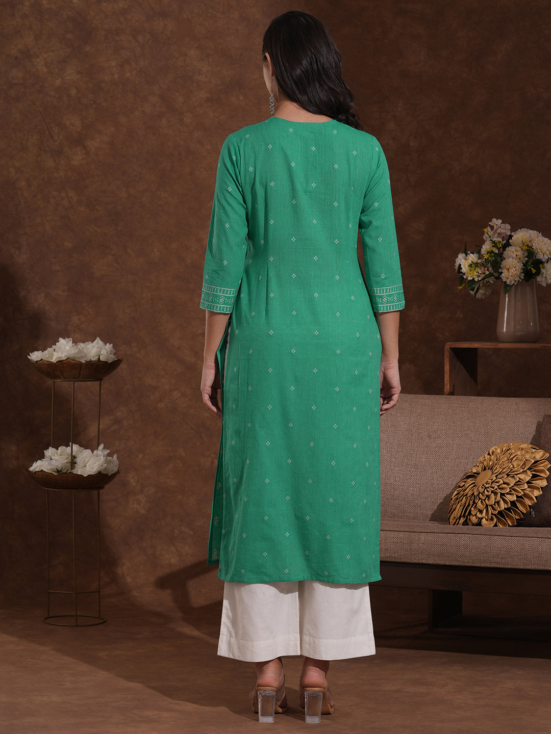 Straight kurta with border detailing on the neck and sleeves with mirrorwork.